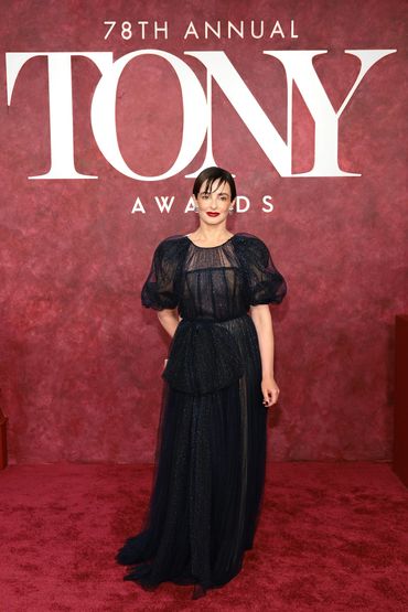 A woman in a dark sparkling gown poses at the 78th Annual Tony Awards.