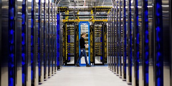 Data center with man walking in background