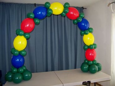 Colorful balloon arch decoration with red, blue, yellow, and green balloons.