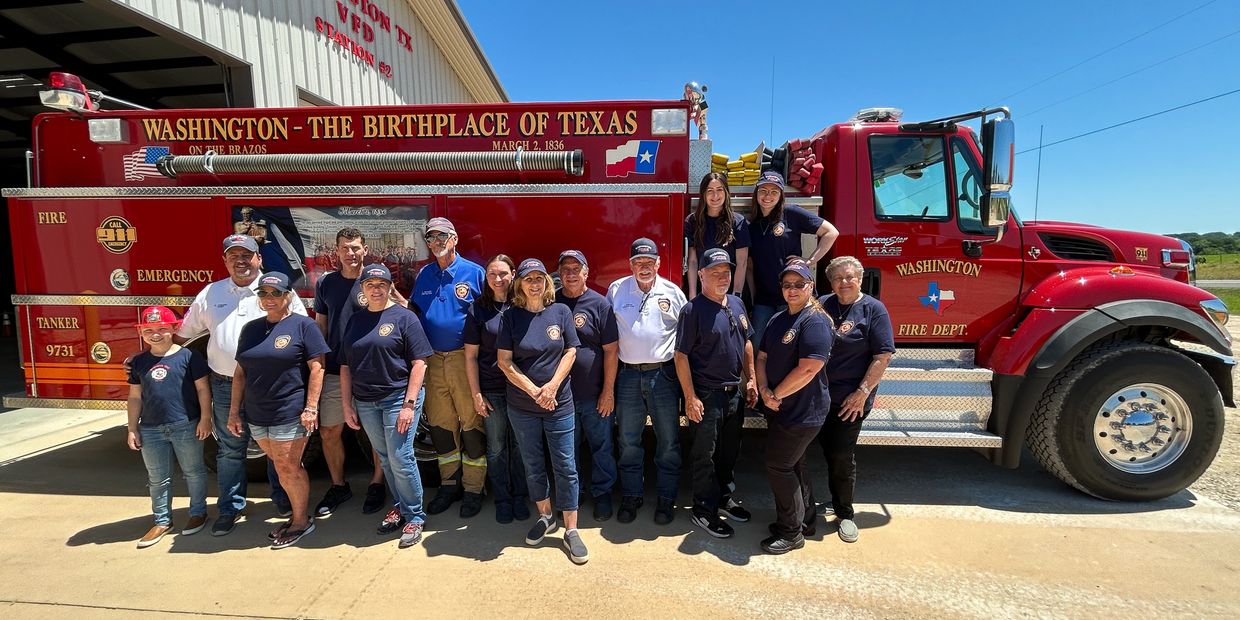 Group photo of Washington Fire Department personnel in front of a red fire truck.