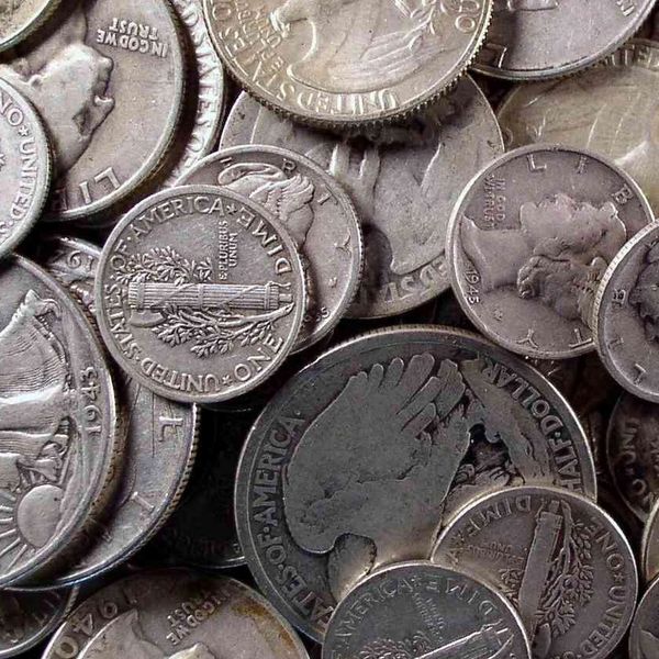 Close-up of various US coins, including dimes and half dollars.
