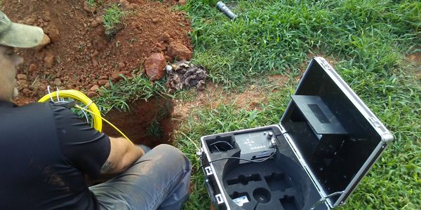 Inspector performing a Septic Inspection. 
Photo: Using camera to view the Septic system.
