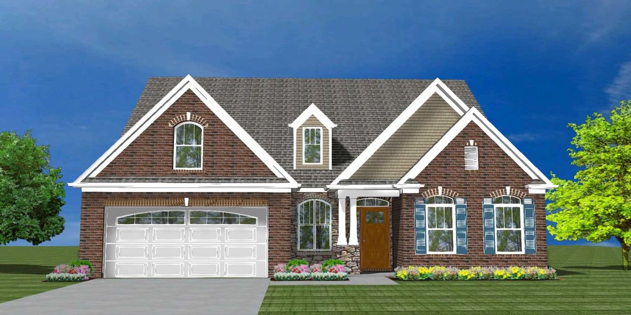 A brick suburban house with a two-car garage and landscaped yard.