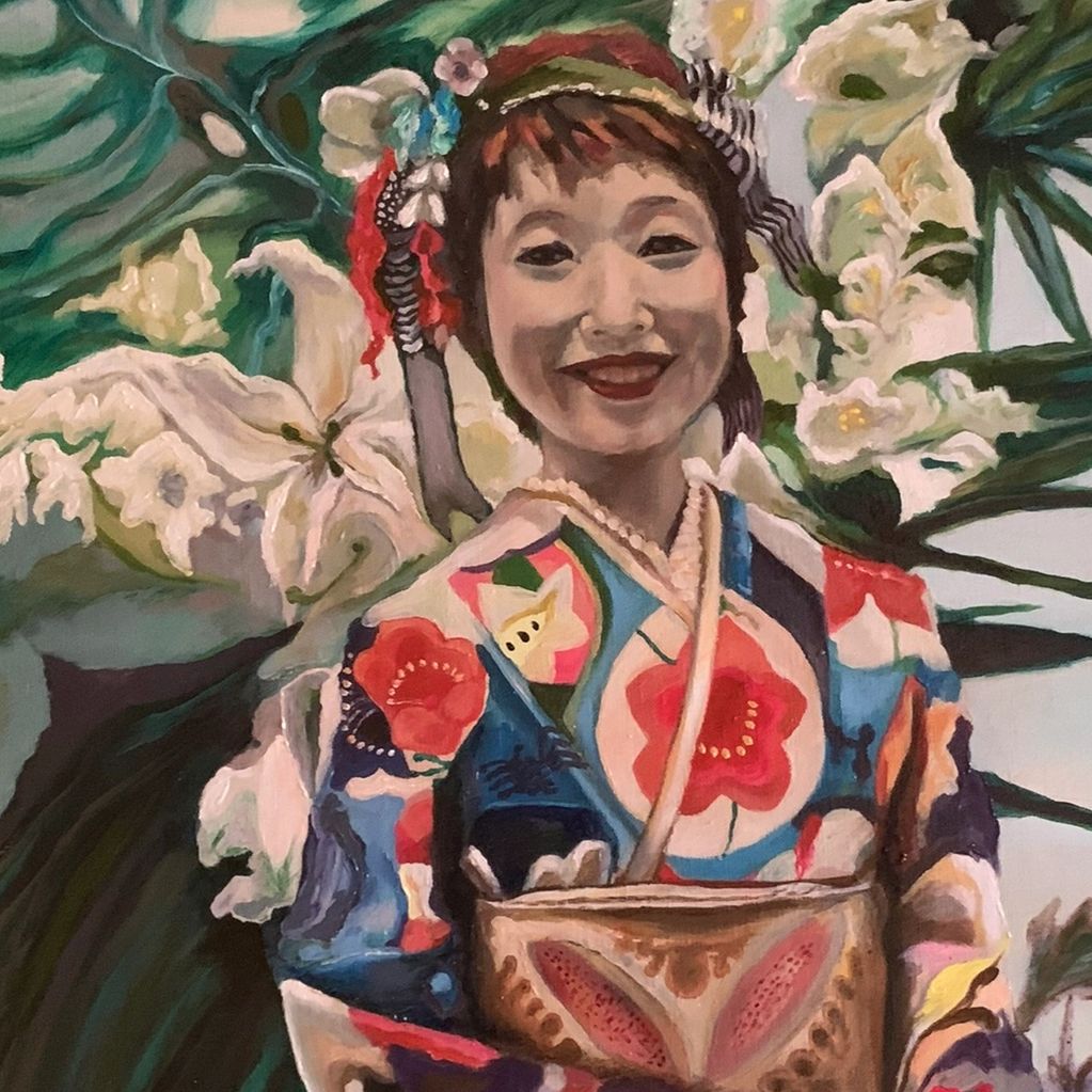 Portrait of a smiling woman in colorful traditional attire with floral background.
