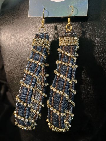 Long denim earrings adorned with sparkling rhinestones and gold accents.
