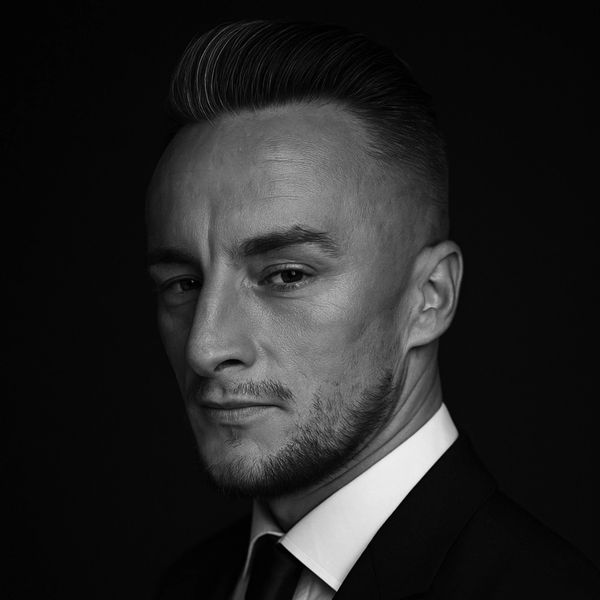 Black and white portrait of a serious man in a suit.