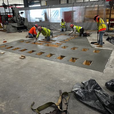 Commercial concrete pour back in Houston with crew finishing slab after saw cutting and demolition