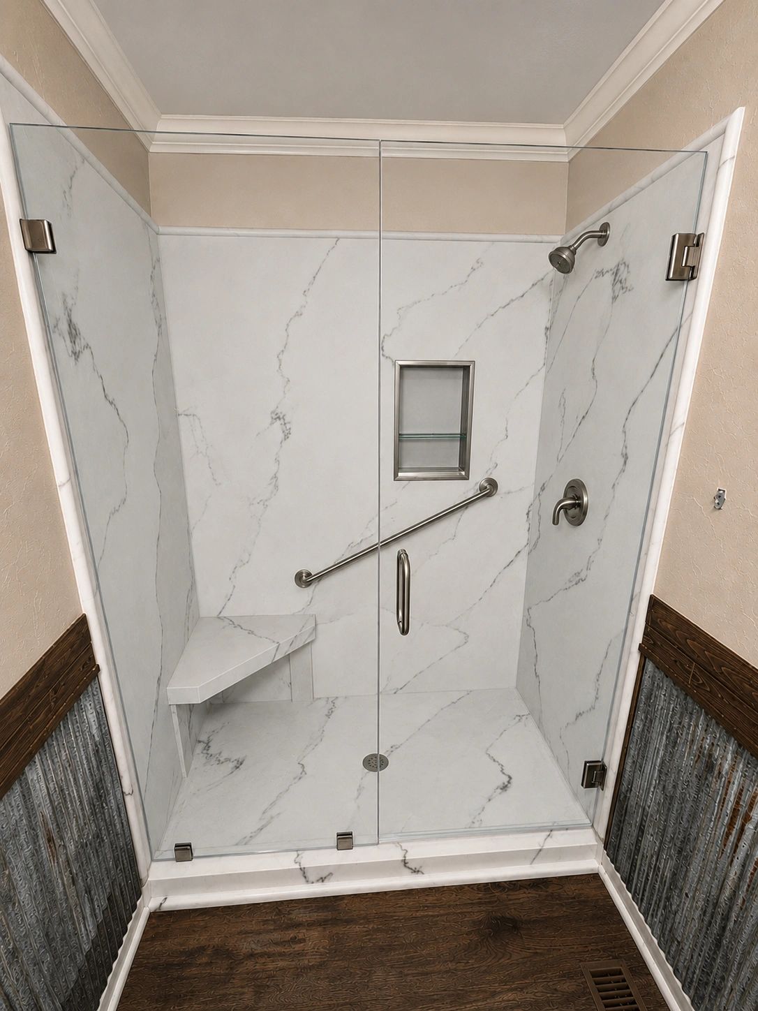 Modern walk-in shower with marble walls and glass door.