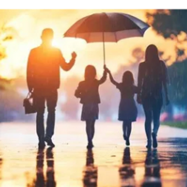 A family walking under an umbrella in the rain during sunset.