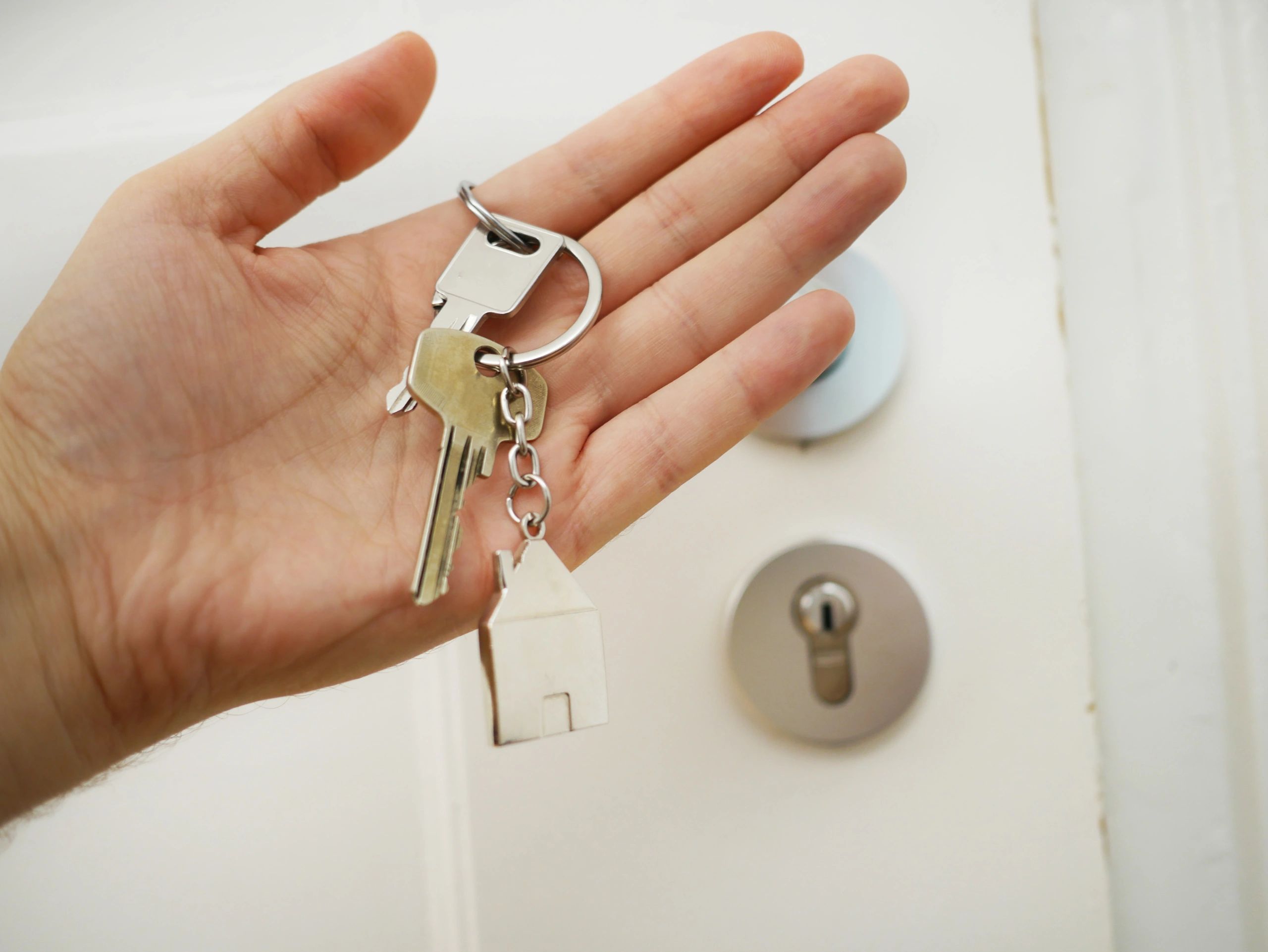 Image of a hand holding house keys.