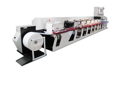 A large industrial printing machine with multiple rollers and white paper roll.
