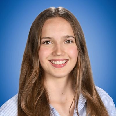 Smiling young woman with long brown hair.