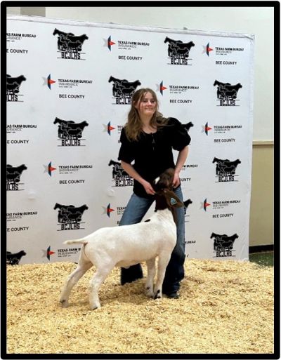 Young woman presenting a goat at a Texas Farm Bureau event.