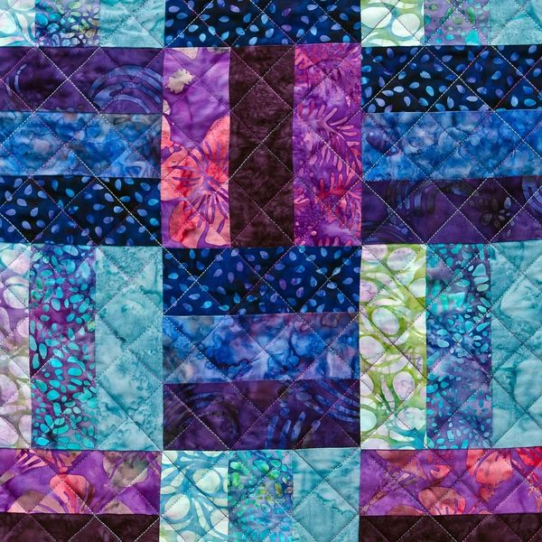 Rail Fence quilt with cross-hatch quilting.