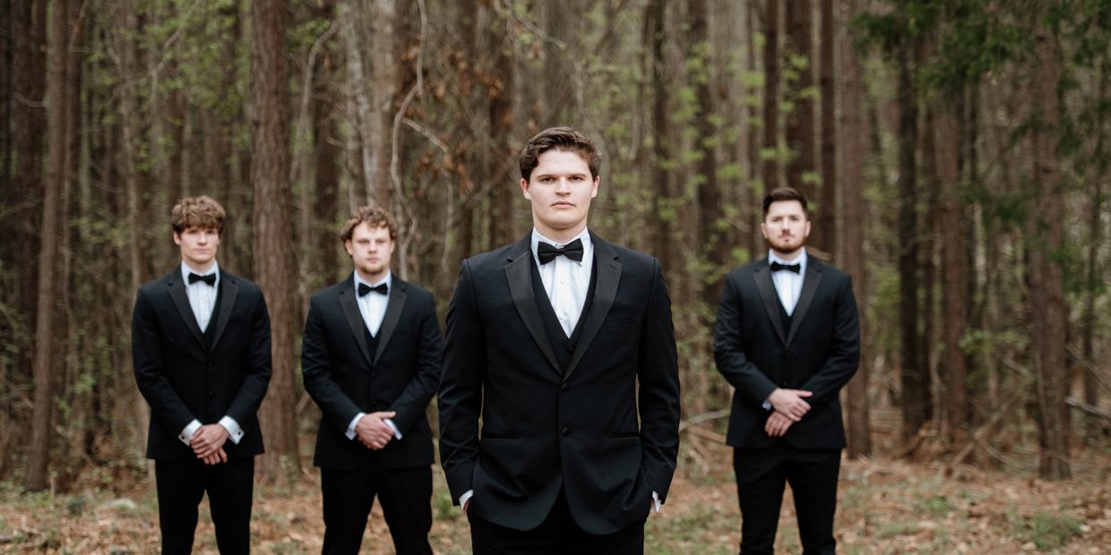 Groom and groomsmen in forest wedding setting at micro wedding venue SC