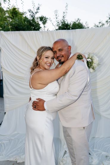 Newlywed couple embracing on their wedding day.