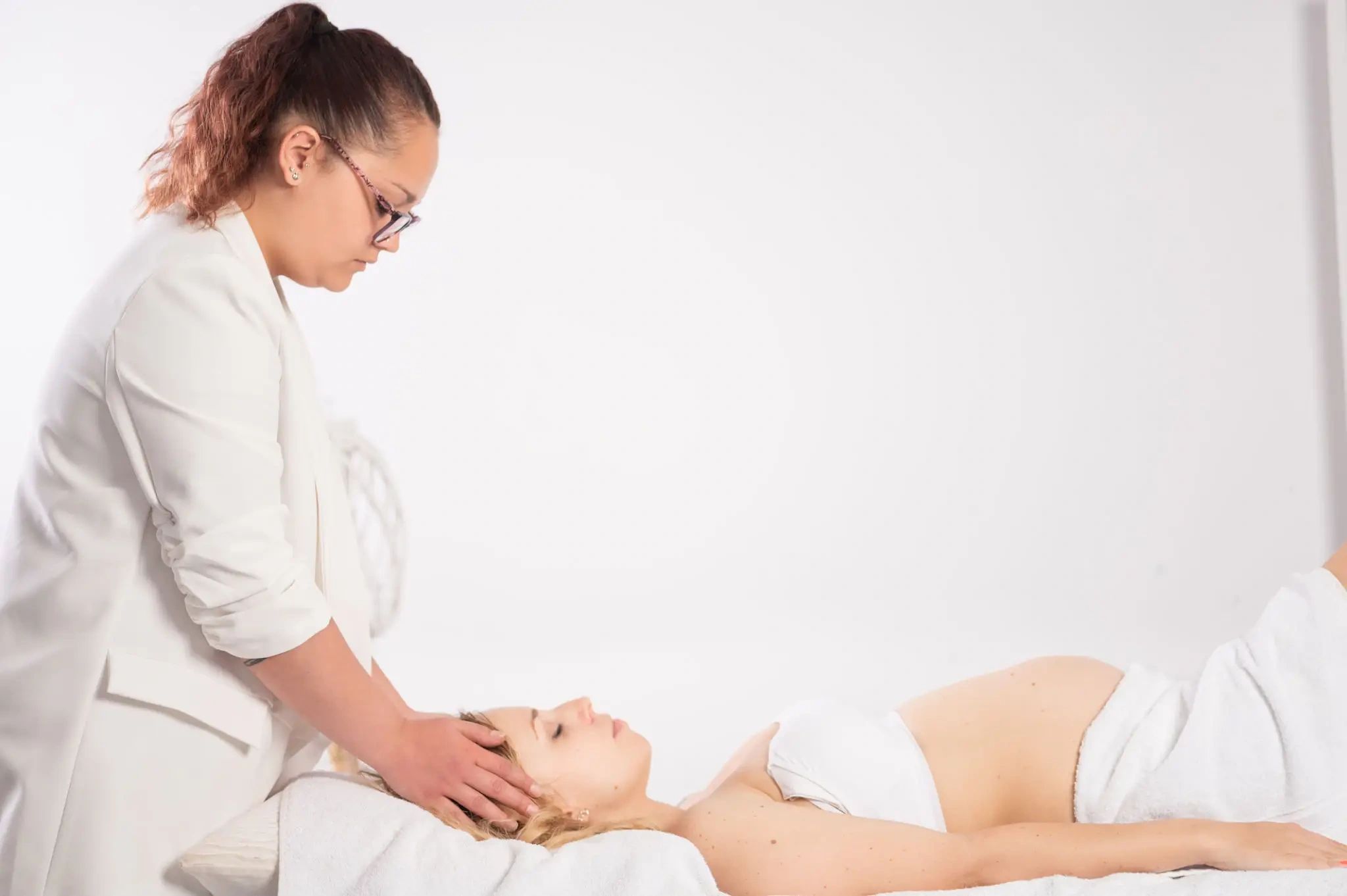 Therapist performing facial head massage.