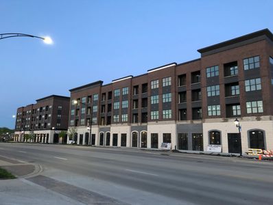 Street view of Riverview Plaza, a multi-story brick building with "Now Leasing" signs.