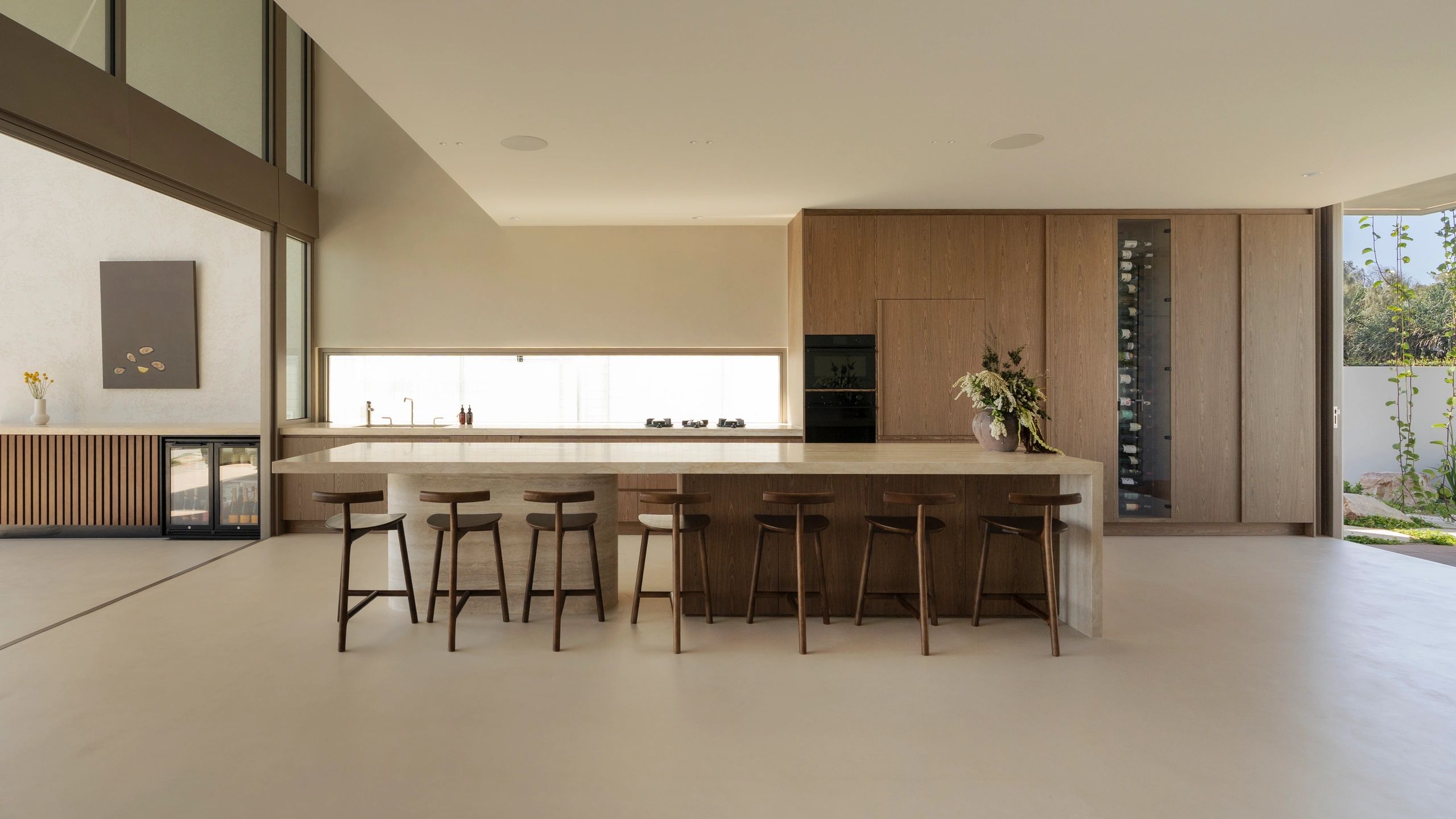 Minimalist kitchen with wooden accents and natural light.