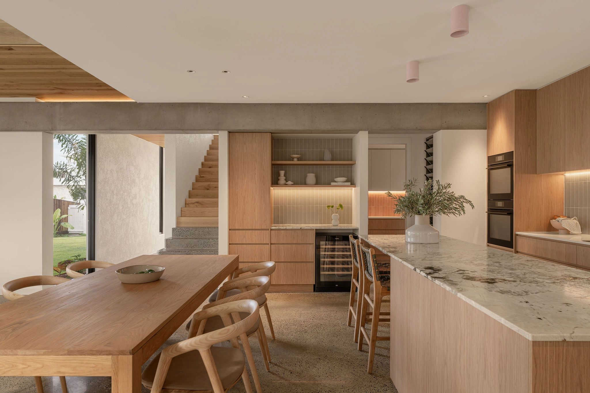 Modern kitchen and dining area with wood finishes.