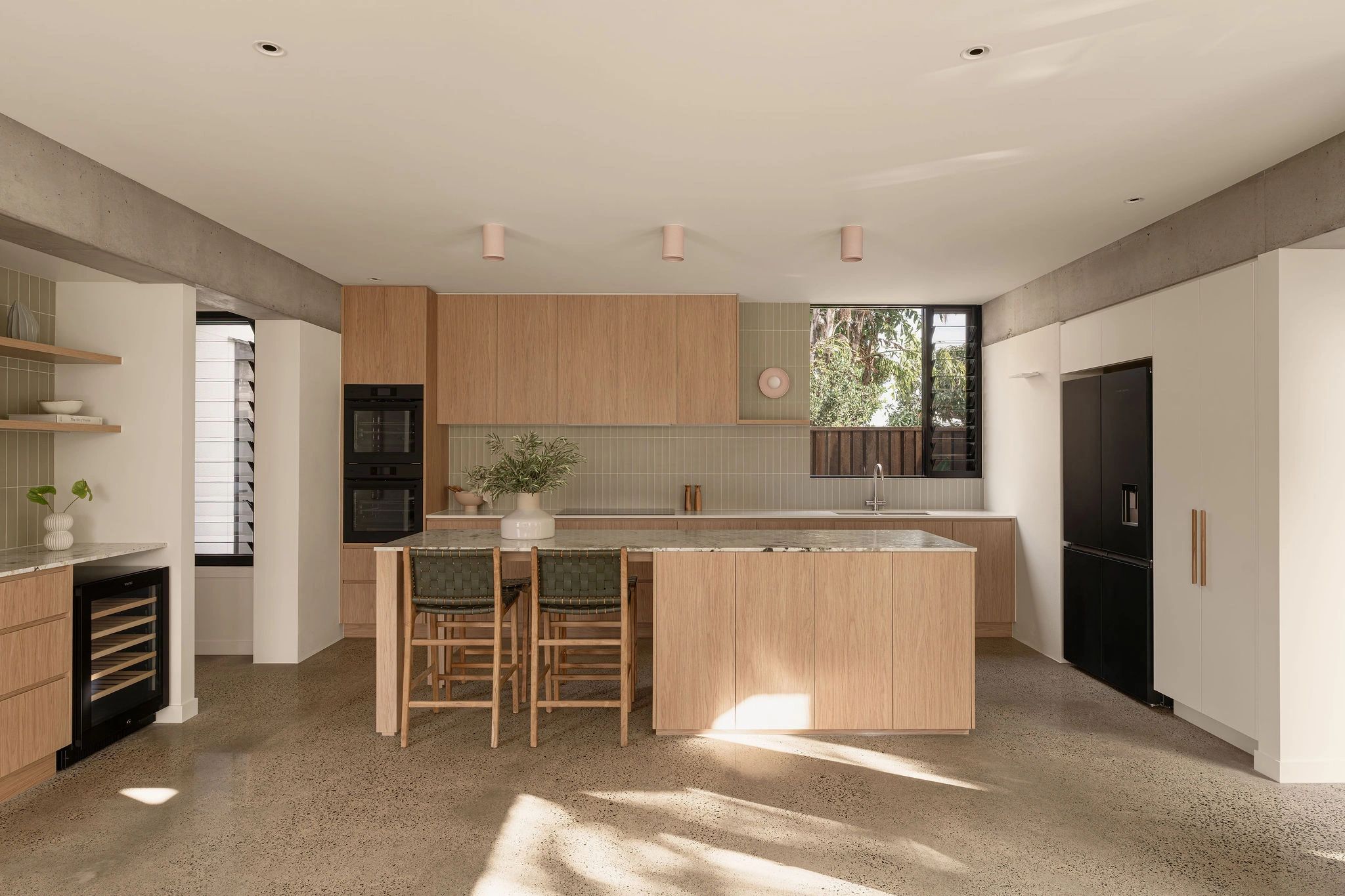 Modern kitchen with wood cabinets and island.