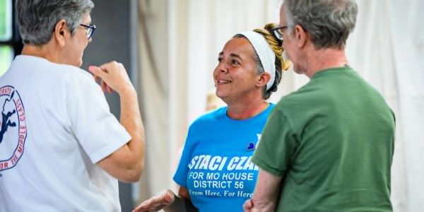 Three people engaged in friendly conversation.