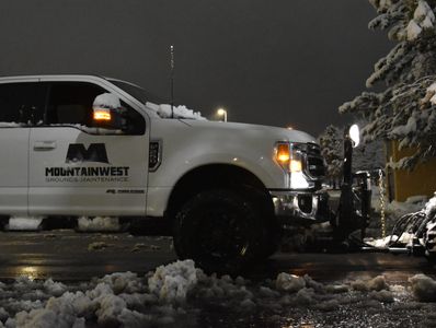 Company F250 plowing snow early in the morning.