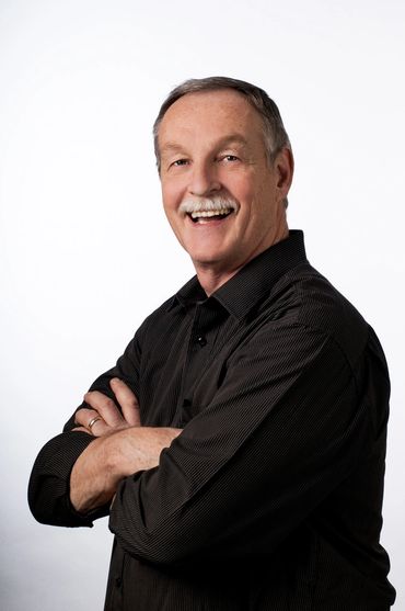 business headshot of a man smiling, on a white back ground