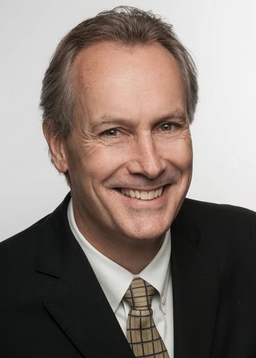 Headshot of a smiling businessman with a white background