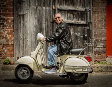 branding portrait of a seventy something man on a scooter