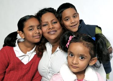 family portrait of four  with a white background
