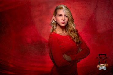 Portrait of a young woman in studio on a red background