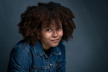 Actor headshot of a young black actress with wild hair