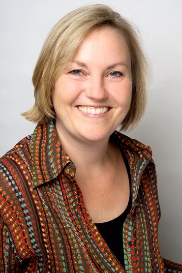 headshot of a smiling woman with a white background