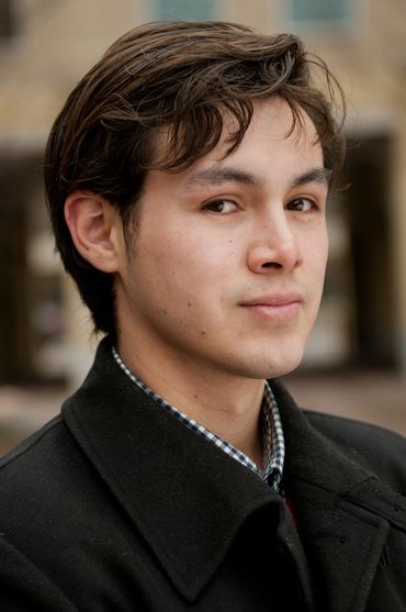 branding headshot of a young man outside