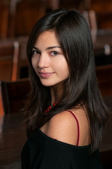 actor headshot of a young woman on location