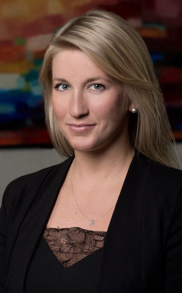 executive headshot of a blond woman in a location