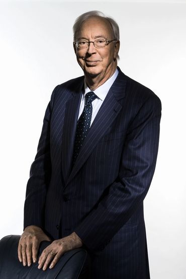 executive headshot of a man in a stripped suit on a white background