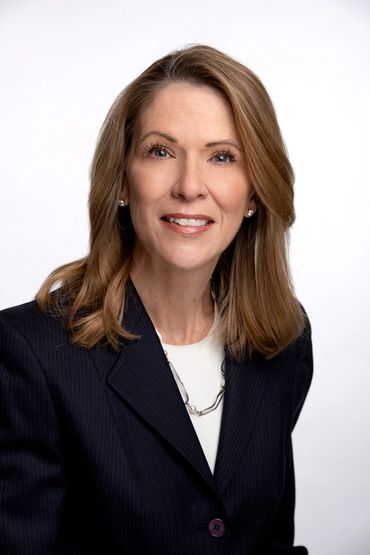 corporate headshot of a fifty's something women with a white background