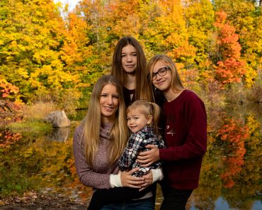 location portrait of a mother and three daughters during the fall season