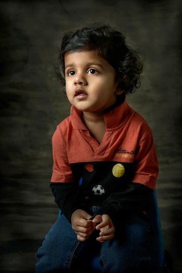 fine art portrait of a three year old boy in a studio