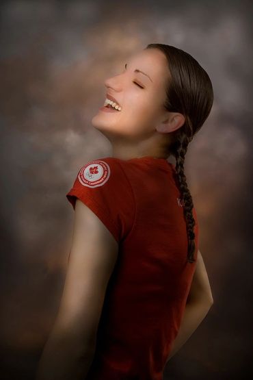 portrait of a very happy young woman in a studio