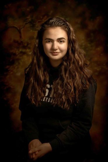 fine art portrait of a young woman with long hair in a studio