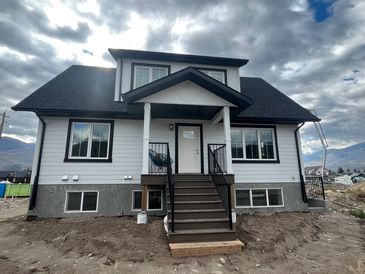 Newly built two-story house under cloudy sky.