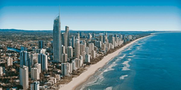 Aerial view of a coastal city with tall buildings along the beach.