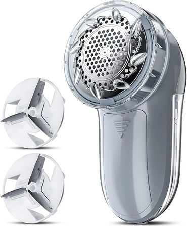 Electric fabric shaver with two replacement blades for removing lint.