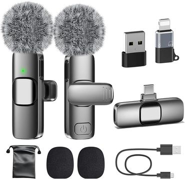 Wireless microphones with furry windshields, adapters, and accessories.