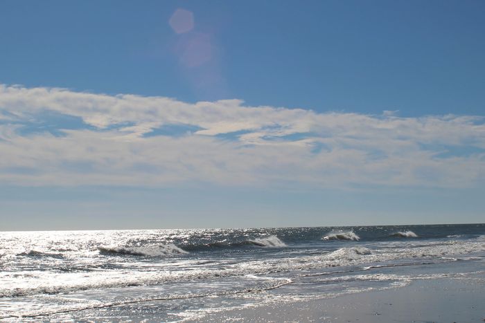 Peaceful waves at the beach on a sunny day.