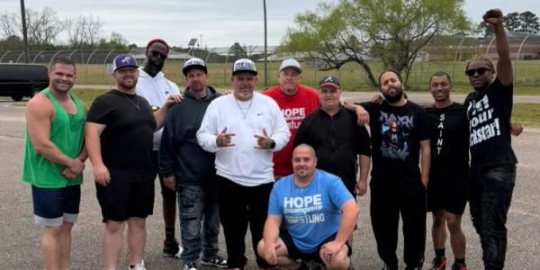 Group of men posing outdoors.