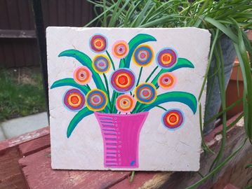 Broken bathroom tile with pink vase filled with abstract circle flowers